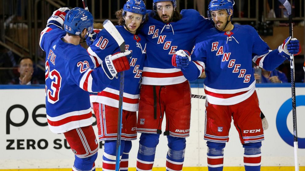 From left to right, New York Rangers players Adam Fox, Artemi Panarin, Mika Zibanejad and Vincent Trocheck celebrate after Zibanejad's goal during the first period of an NHL hockey game against the Detroit Red Wings, Sunday, Nov. 6, 2022, in New York