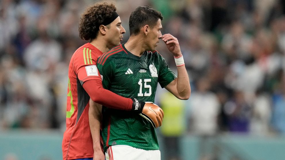 Mexico's goalkeeper Guillermo Ochoa embraces teammate Hector Moreno, right, at the end of the World Cup group C soccer match between Argentina and Mexico, at the Lusail Stadium in Lusail, Qatar, Saturday, Nov. 26, 2022. Argentina won 2-0. (AP Photo/M