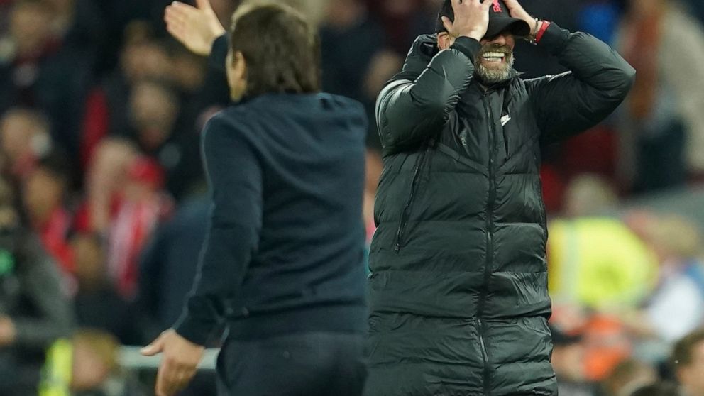 Liverpool's manager Jurgen Klopp, right, gestures during the English Premier League soccer match between Liverpool and Tottenham Hotspur at Anfield stadium in Liverpool, England, Saturday, May 7, 2022. (AP Photo/Jon Super)