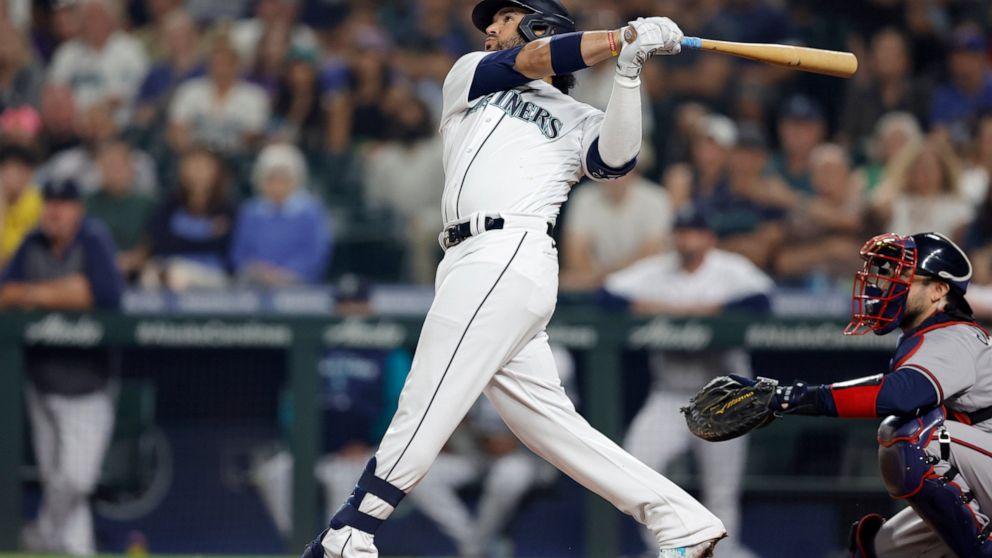 Seattle Mariners' Eugenio Suarez hits a solo home run on a pitch from Atlanta Braves starting pitcher Max Fried during the sixth inning a baseball game, Saturday, Sept. 10, 2022, in Seattle. (AP Photo/John Froschauer)