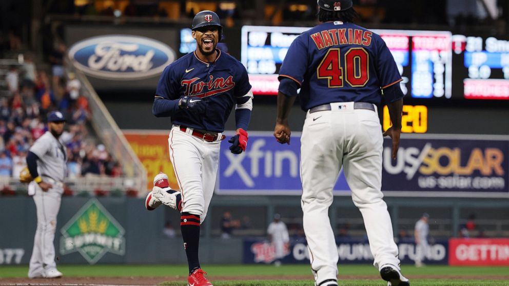 Minnesota Twins' Byron Buxton smiles on his way to home plate after hitting his second home run of the night, during the fifth inning of a baseball game against the Tampa Bay Rays, Friday, June 10, 2022, in Minneapolis. (AP Photo/Stacy Bengs)