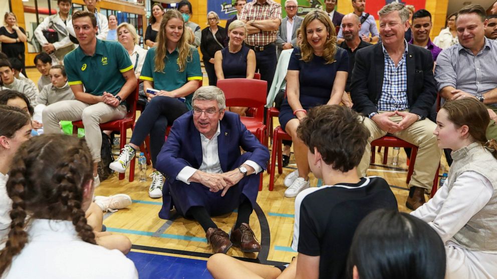 International Olympic Committee President Thomas Bach, center, speaks with young athletes at the Olympics Unleashed session at the Yeronga Park Sports Centre in Brisbane, Australia, Saturday, May 7, 2022. Bach was in Brisbane on Saturday for the firs