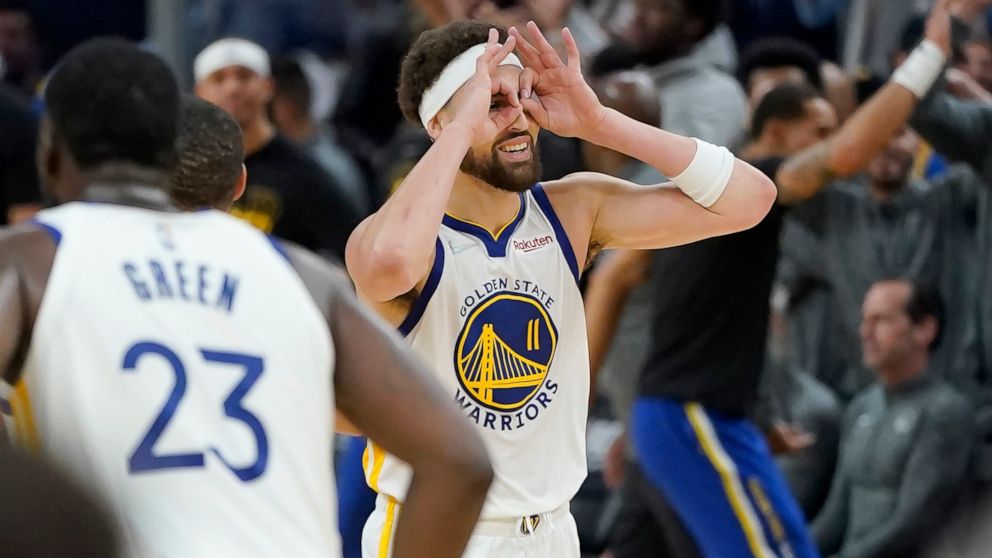 Golden State Warriors guard Klay Thompson (11) gestures after teammate Stephen Curry's 3-point basket during the first half of Game 2 of an NBA basketball first-round playoff series against the Denver Nuggets in San Francisco, Monday, April 18, 2022.