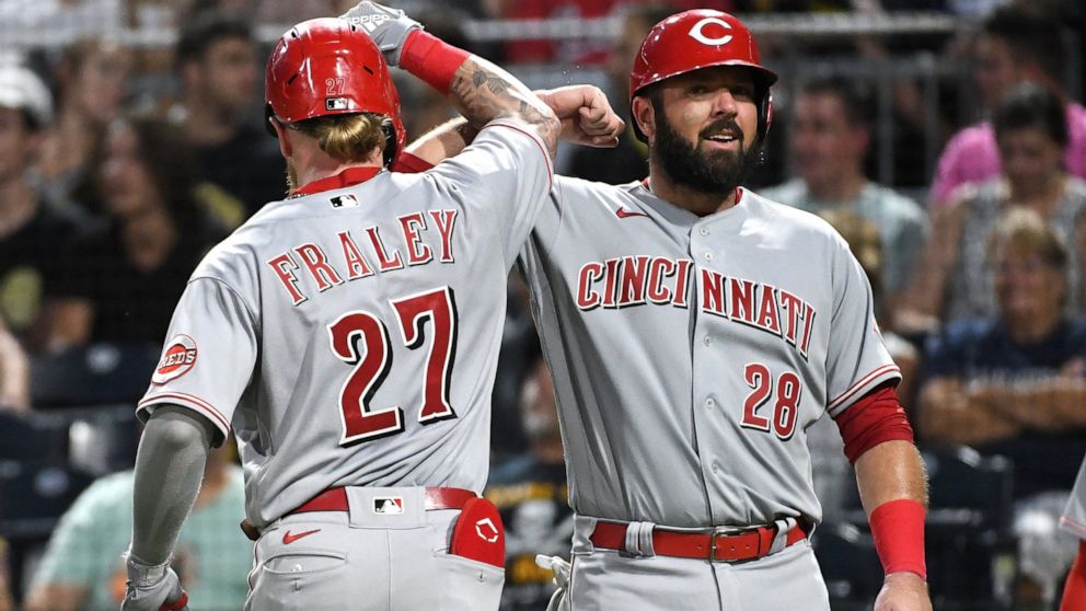 Cincinnati Reds' Jake Fraley is greeted by teammate Austin Romine (28) after his two-run home run off Pittsburgh Pirates pitcher Tyler Beede scored them both during the fourth inning of a baseball game, Saturday, Aug. 20, 2022, in Pittsburgh. (AP Pho