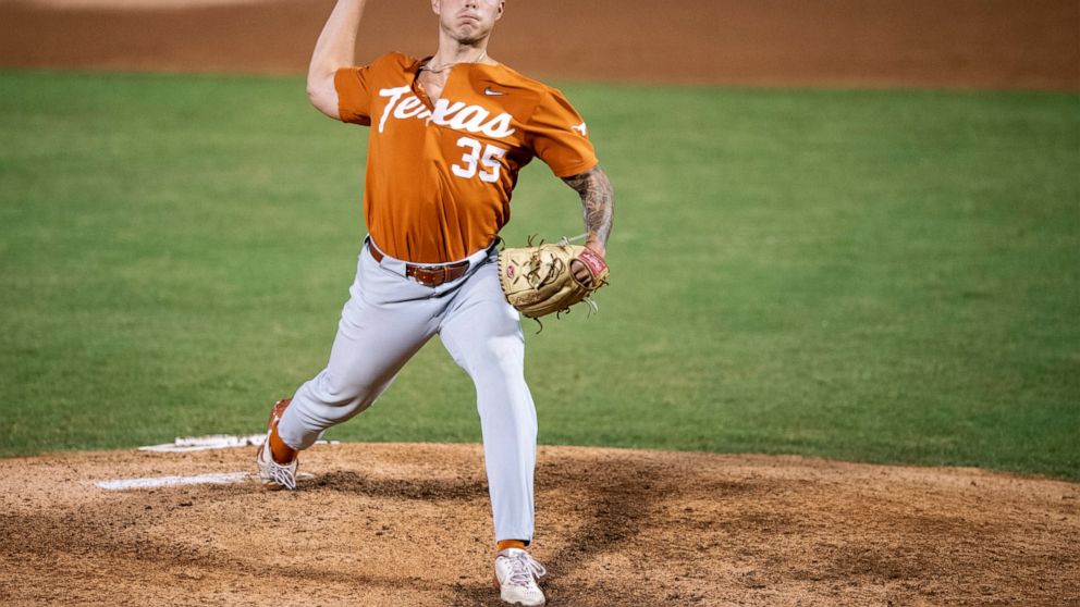 Texas' Tristan Stevens throws a pitch during the first inning of an NCAA college super regional baseball game against East Carolina on Sunday, June 12, 2022, in Greenville, N.C. (AP Photo/Matt Kelley)