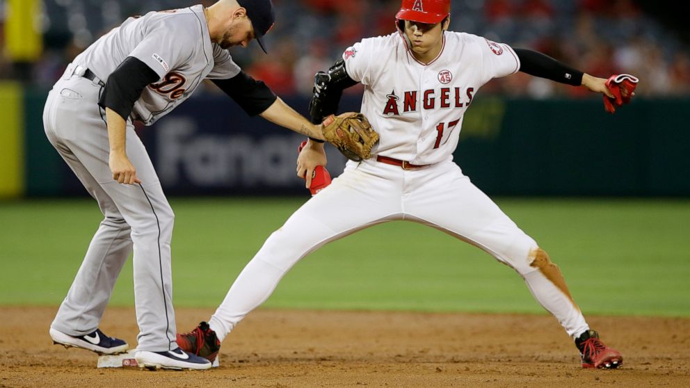 Los Angeles Angels' Shohei Ohtani, right, avoids the tag by Detroit Tigers shortstop Jordy Mercer to steal second base during the third inning of a baseball game in Anaheim, Calif., Tuesday, July 30, 2019. (AP Photo/Alex Gallardo)