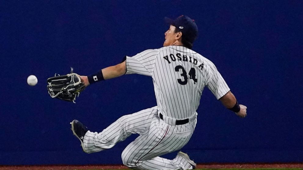 FILE - Japan's Masataka Yoshida cannot reach a ball hit by United States' Triston Casas during the seventh inning of a baseball game at the 2020 Summer Olympics, Aug. 2, 2021, in Yokohama, Japan. The Boston Red Sox have agreed to terms with Japanese 
