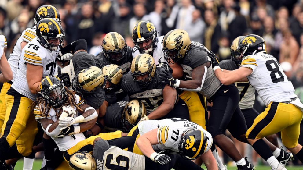 Iowa running back Jaziun Patterson,left, carries the ball during the second half of an NCAA college football game against Purdue, Saturday, Nov. 5, 2022, in West Lafayette, Ind. (AP Photo/Marc Lebryk)