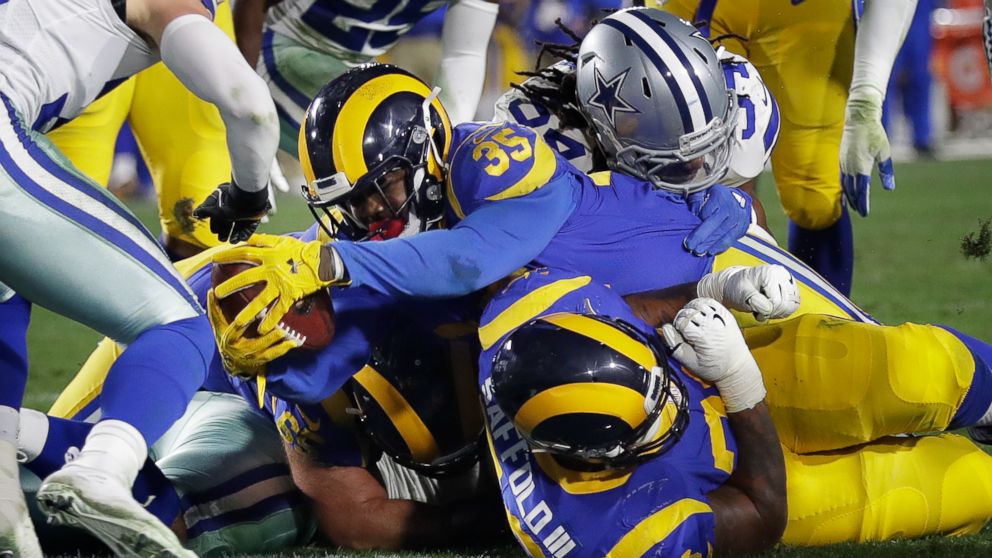 Los Angeles Rams running back C.J. Anderson scores against the Dallas Cowboys during the first half in an NFL divisional football playoff game Saturday, Jan. 12, 2019, in Los Angeles. (AP Photo/Marcio Jose Sanchez)