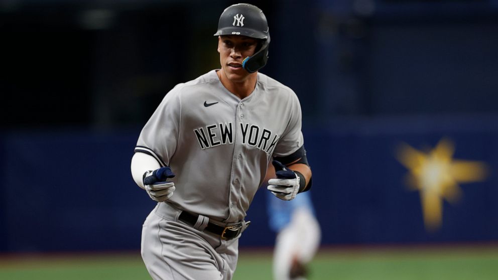 New York Yankees' Aaron Judge point to the dugout while circling the bases after hitting a home run against the Tampa Bay Rays during the first inning of a baseball game Sunday, Sept. 4, 2022, in St. Petersburg, Fla. (AP Photo/Scott Audette)
