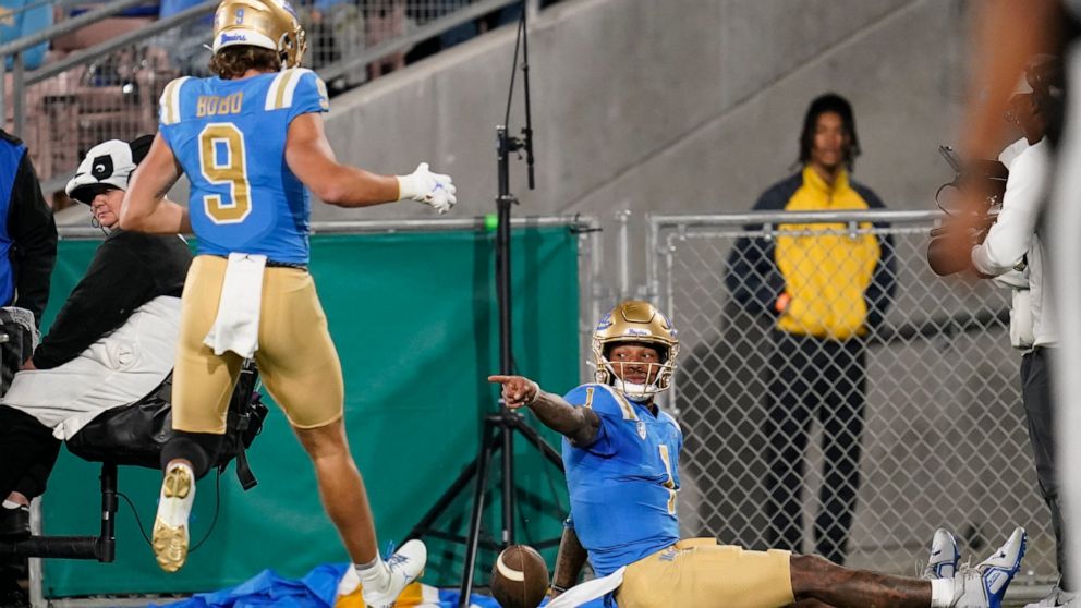 UCLA quarterback Dorian Thompson-Robinson (1) celebrates with wide receiver Jake Bobo (9) after scoring a touchdown during the first half of an NCAA college football game against Stanford in Pasadena, Calif., Saturday, Oct. 29, 2022. (AP Photo/Ashley