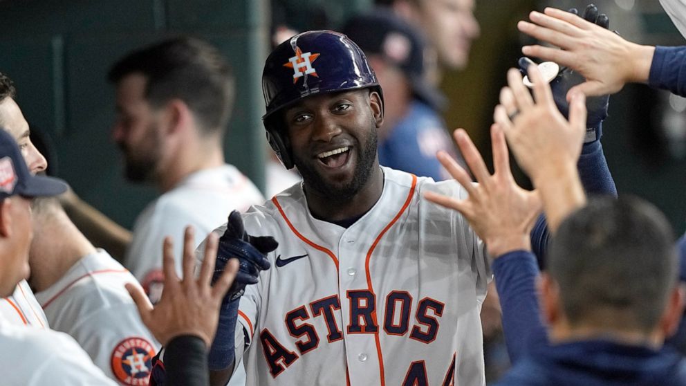 Houston Astros' Yordan Alvarez (44) celebrates with teammates in the dugout after hitting a home run against the New York Mets during the third inning of a baseball game Wednesday, June 22, 2022, in Houston. (AP Photo/David J. Phillip)