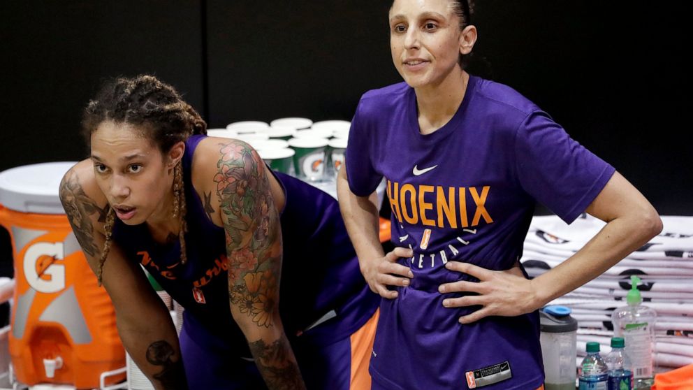 FILE - Phoenix Mercury's Brittney Griner, left, watches practice with teammate Diana Taurasi on Thursday, May 10, 2018, in Phoenix. Since arriving a Moscow airport in mid-February, Griner has been detained by police after they reported finding vape c