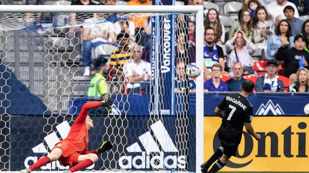 Minnesota United's Franco Fragapane (7) scores against Vancouver Whitecaps goalkeeper Cody Cropper during the second half of an MLS soccer match Friday, July 8, 2022, in Vancouver, British Columbia. (Darryl Dyck/The Canadian Press via AP)