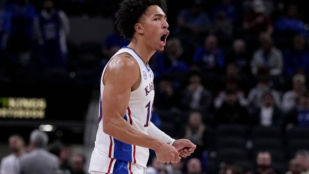 Kansas forward Jalen Wilson (10) reacts to a score against Duke during the second half of an NCAA college basketball game, Wednesday, Nov. 16, 2022, in Indianapolis. (AP Photo/Darron Cummings)