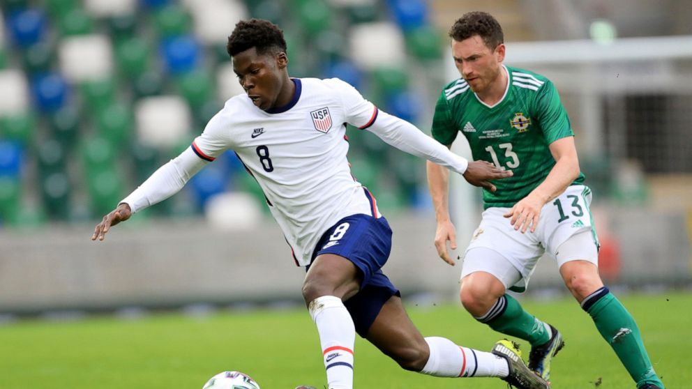 FILE - United States's Yunus Musah, left, duels for the ball with Northern Ireland's Corry Evans during an international friendly soccer match between Northern Ireland and United States, at Windsor Park, Belfast, Northern Ireland, on March 28, 2021. 