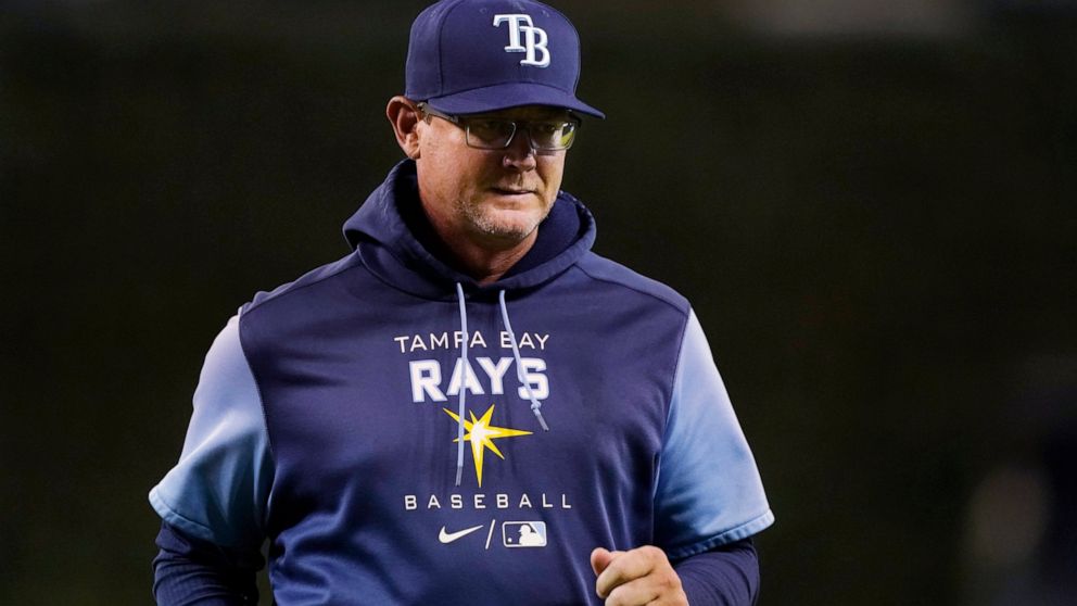 Tampa Bay Rays pitching coach Kyle Snyder walks back to the dugout after a mound visit during the ninth inning of the team's baseball game against the Detroit Tigers, Thursday, Aug. 4, 2022, in Detroit. Snyder injured himself walking toward the mound