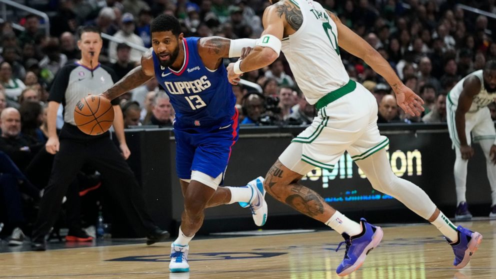 Los Angeles Clippers' Paul George (13) drives toward the basket as he is pressured by Boston Celtics' Jayson Tatum during first half of an NBA basketball game, Monday, Dec. 12, 2022, in Los Angeles. (AP Photo/Jae C. Hong)
