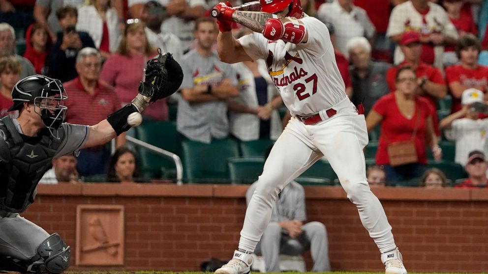 Colorado Rockies catcher Brian Serven, left, reaches for the ball after St. Louis Cardinals' Tyler O'Neill (27) was hit by a pitch with the bases loaded to score Andrew Knizner ending a baseball game Tuesday, Aug. 16, 2022, in St. Louis. The Cardinal