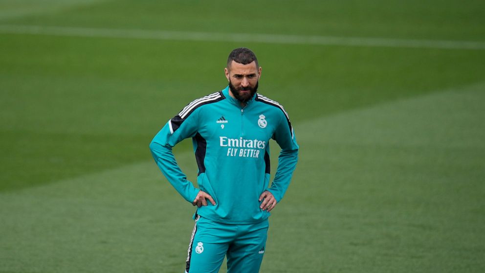 Real Madrid's Karim Benzema stands on the pitch during a Media Opening day training session in Madrid, Spain, Tuesday, May 24, 2022. Real Madrid will play Liverpool in Saturday's Champions League soccer final in Paris. (AP Photo/Manu Fernandez)