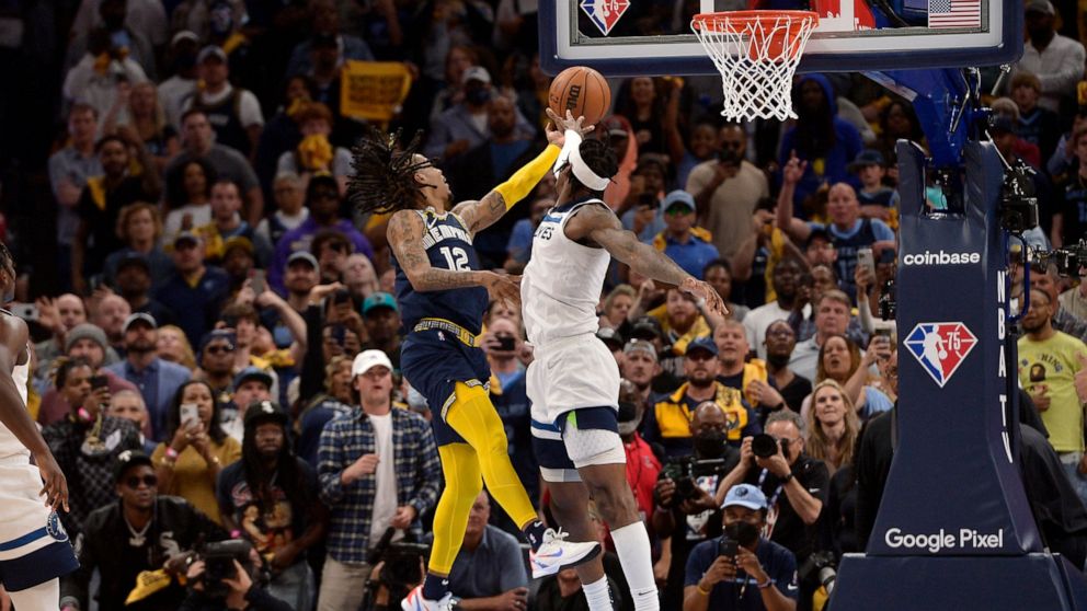 Memphis Grizzlies guard Ja Morant (12) takes the game winning shot against Minnesota Timberwolves forward Jarred Vanderbilt (8) in the second half during Game 5 of a first-round NBA basketball playoff series Tuesday, April 26, 2022, in Memphis, Tenn.
