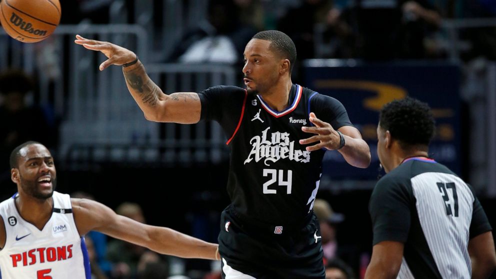 Los Angeles Clippers forward Norman Powell (24) passes the ball against Detroit Pistons guard Alec Burks (5) with referee Mitchell Ervin (27) watching the action during the first half of an NBA basketball game, Monday, Dec. 26, 2022, in Detroit. (AP 