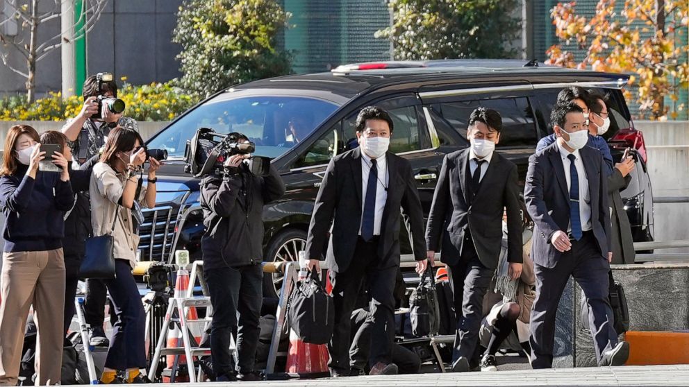 Investigators enter the headquarters of major advertising company Dentsu in Tokyo Friday, Nov. 25, 2022. Japanese prosecutors raided the headquarters of Dentsu Friday, as the investigation into corruption related to the Tokyo Olympics widened. (Kyodo