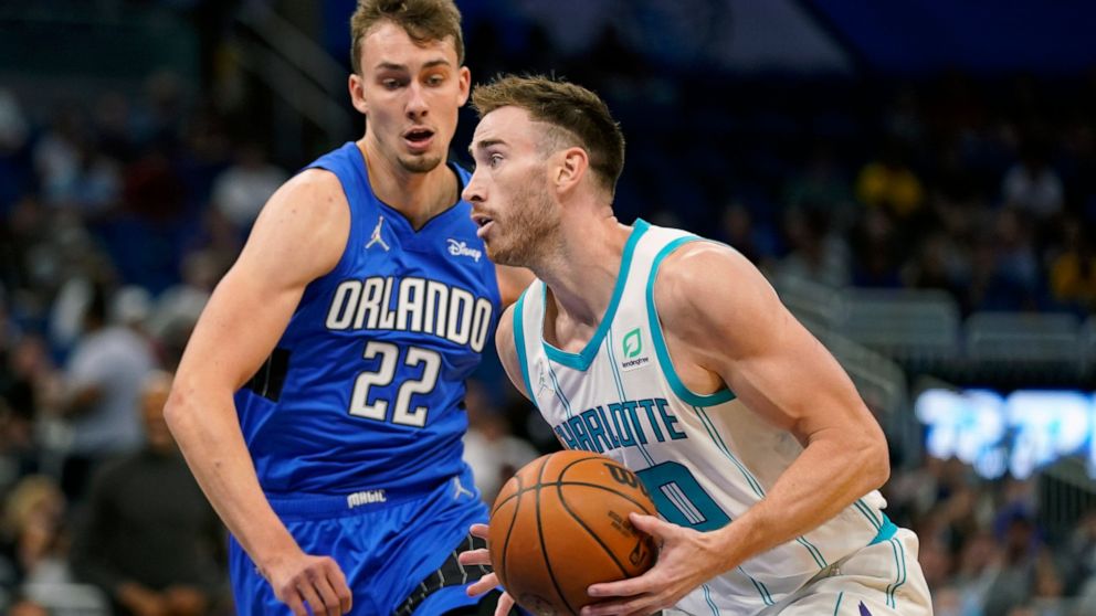 Charlotte Hornets' Gordon Hayward, right, moves to the basket against Orlando Magic's Franz Wagner (22) during the first half of an NBA basketball game, Wednesday, Oct. 27, 2021, in Orlando, Fla. (AP Photo/John Raoux)
