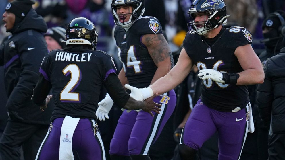 Baltimore Ravens quarterback Tyler Huntley (2) celebrates his touchdown pass with tight end Josh Oliver and tight end Nick Boyle (86) during the first half of an NFL football game, Saturday, Dec. 24, 2022, in Baltimore. (AP Photo/Julio Cortez)