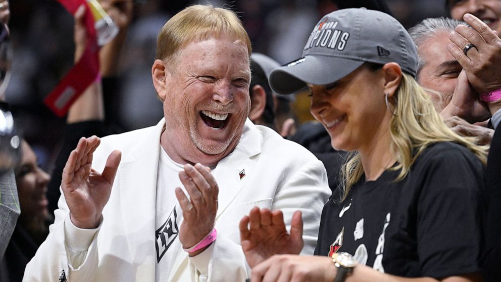 Las Vegas Aces owner Mark Davis, celebrates his team's win with Las Vegas Aces head coach Becky Hammon in the WNBA basketball finals against the Connecticut Sun, Sunday, Sept. 18, 2022, in Uncasville, Conn. (AP Photo/Jessica Hill)