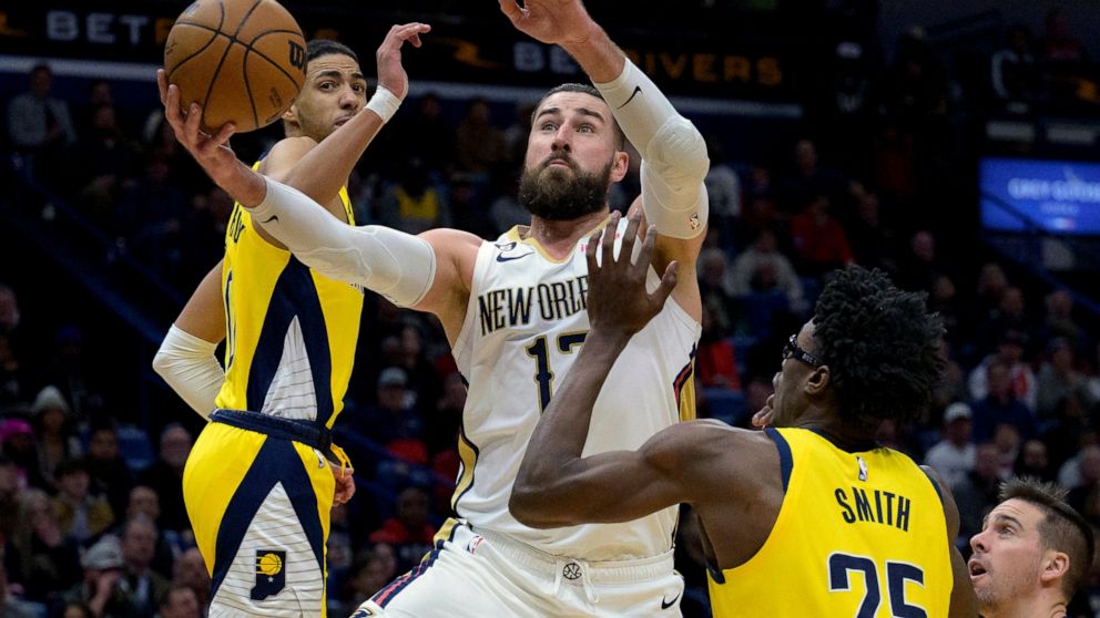 New Orleans Pelicans center Jonas Valanciunas (17) shoots against Indiana Pacers guard Tyrese Haliburton, left, and Indiana Pacers forward Jalen Smith (25) in the first half of an NBA basketball game in New Orleans, Monday, Dec. 26, 2022. (AP Photo/M