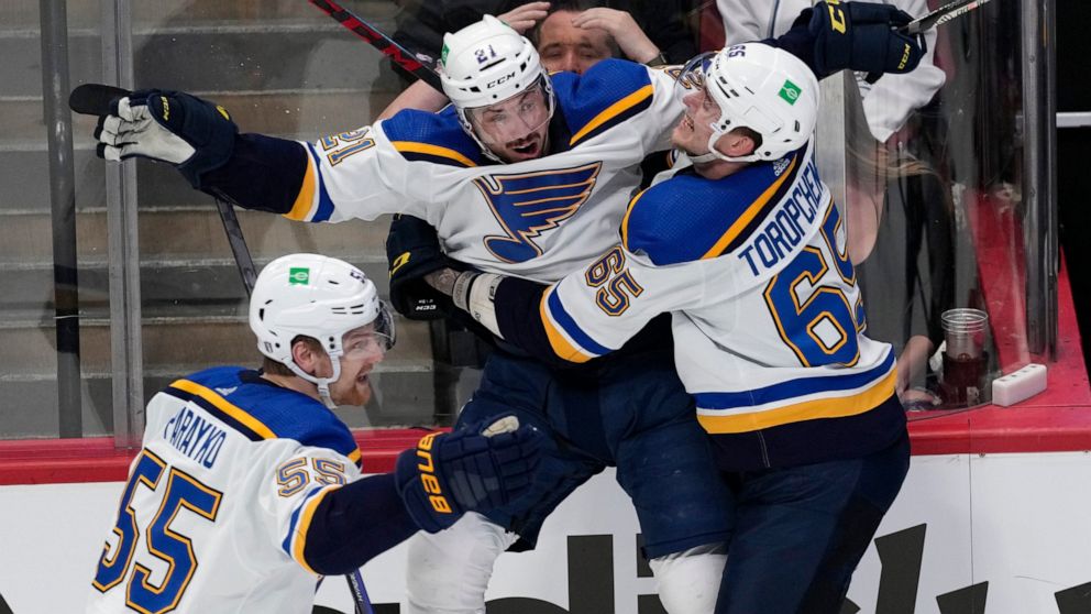 St. Louis Blues center Tyler Bozak, middle, celebrates his overtime goal against the Colorado Avalanche with right wing Alexei Toropchenko in Game 5 of an NHL hockey Stanley Cup second-round playoff series Wednesday, May 25, 2022, in Denver. At left 