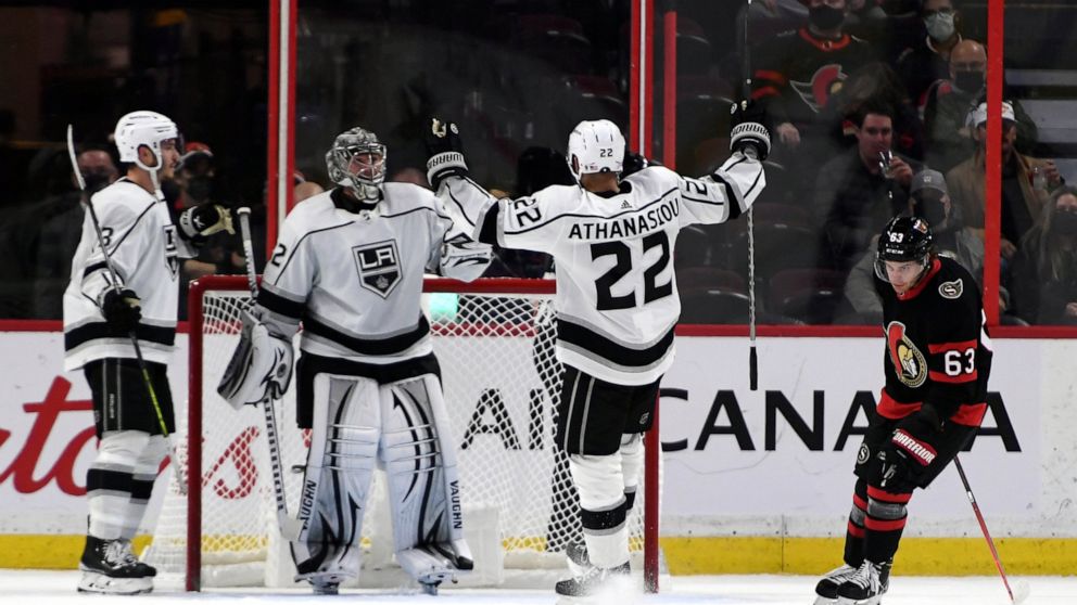 Los Angeles Kings' Andreas Athanasiou (22) celebrates his team's win over the Ottawa Senators with goaltender Jonathan Quick (32) as Senators' Tyler Ennis (63) skates away at the end of the third period of an NHL hockey game in Ottawa, Ontario, Thurs