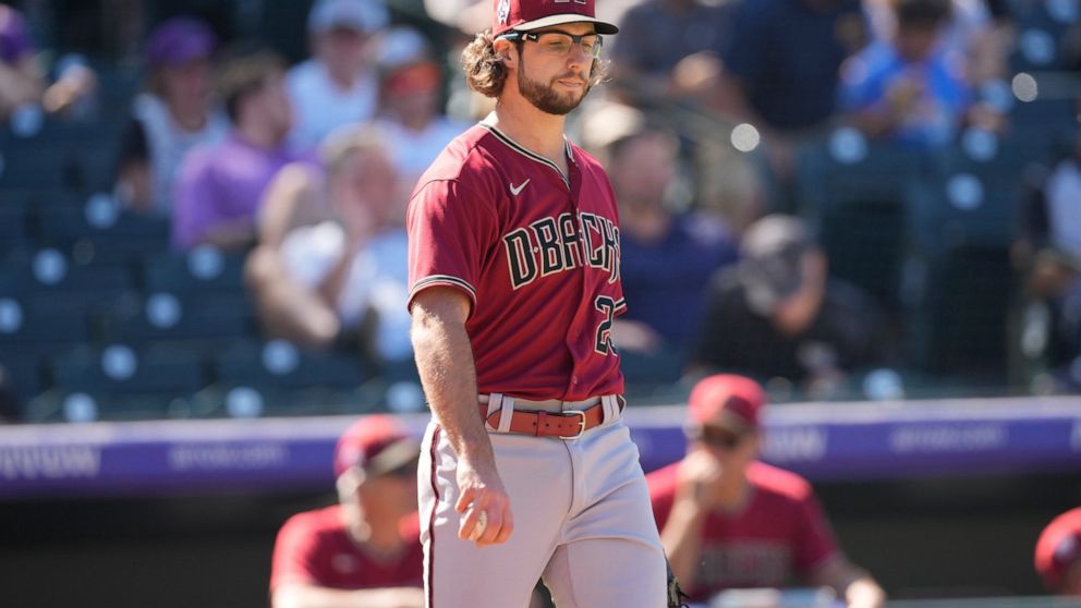 Arizona Diamondbacks starting pitcher Zac Gallen reacts after giving up an RBI-single to Colorado Rockies' C.J. Cron in the fourth inning of a baseball game Sunday, Sept. 11, 2022, in Denver. (AP Photo/David Zalubowski)