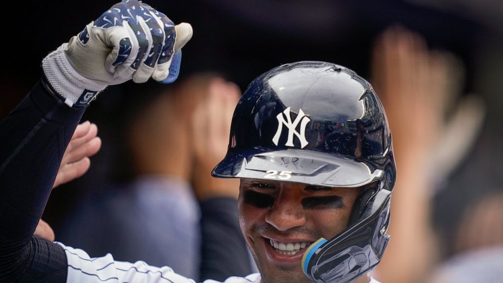 New York Yankees' Gleyber Torres celebrates in the dugout after hitting a three-run home run off Toronto Blue Jays starting pitcher Jose Berrios (17) in the fourth inning of a baseball game, Wednesday, May 11, 2022, in New York. (AP Photo/John Minchillo)