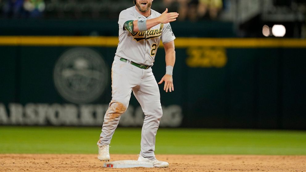 Oakland Athletics' Stephen Vogt (21) stands on second celebrating his run-scoring single in the ninth inning of a baseball game against the Texas Rangers in Arlington, Texas, Wednesday, Sept. 14, 2022. Eric Martins scored on the hit and Vogt advanced