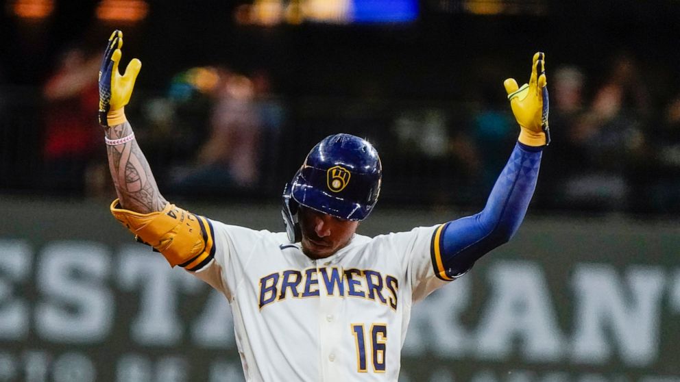 Milwaukee Brewers' Kolten Wong reacts after two runs scored on his hit during the fifth inning of a baseball game against the Tampa Bay Rays Tuesday, Aug. 9, 2022, in Milwaukee. (AP Photo/Morry Gash)