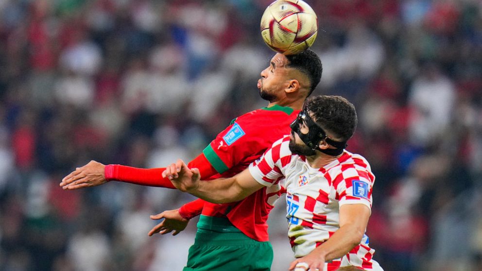 Morocco's Youssef En-Nesyri, left, and Croatia's Josko Gvardiol fight for the ball during the World Cup third-place playoff soccer match between Croatia and Morocco at Khalifa International Stadium in Doha, Qatar, Saturday, Dec. 17, 2022. (AP Photo/H
