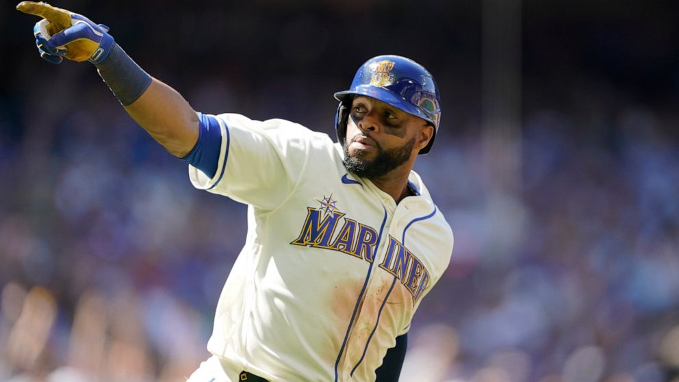 Seattle Mariners' Carlos Santana gestures as he heads to first after hitting a two-run home run against the Toronto Blue Jays during the eighth inning of a baseball game, Sunday, July 10, 2022, in Seattle. Santana had two home runs and the Mariners w