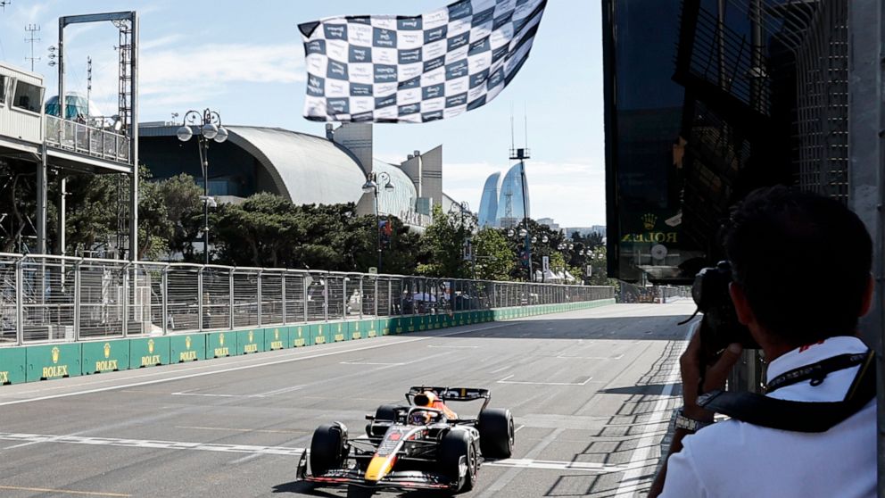Red Bull driver Max Verstappen of the Netherlands crosses the finish line to win the Azerbaijan Formula One Grand Prix at the Baku circuit, in Baku, Azerbaijan, Sunday, June 12, 2022. (Hamad Mohammed, Pool Via AP)