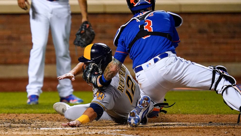 New York Mets catcher Tomas Nido (3) tags out Milwaukee Brewers' Hunter Renfroe during the ninth inning of a baseball game Thursday, June 16, 2022, in New York. The Mets won 5-4. (AP Photo/Frank Franklin II)