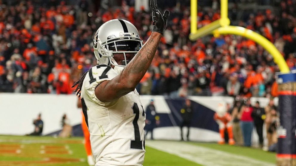 Las Vegas Raiders wide receiver Davante Adams (17) waves after scoring the winning touchdown against the Denver Broncos during overtime of an NFL football game in Denver, Sunday, Nov. 20, 2022. (AP Photo/Jack Dempsey)