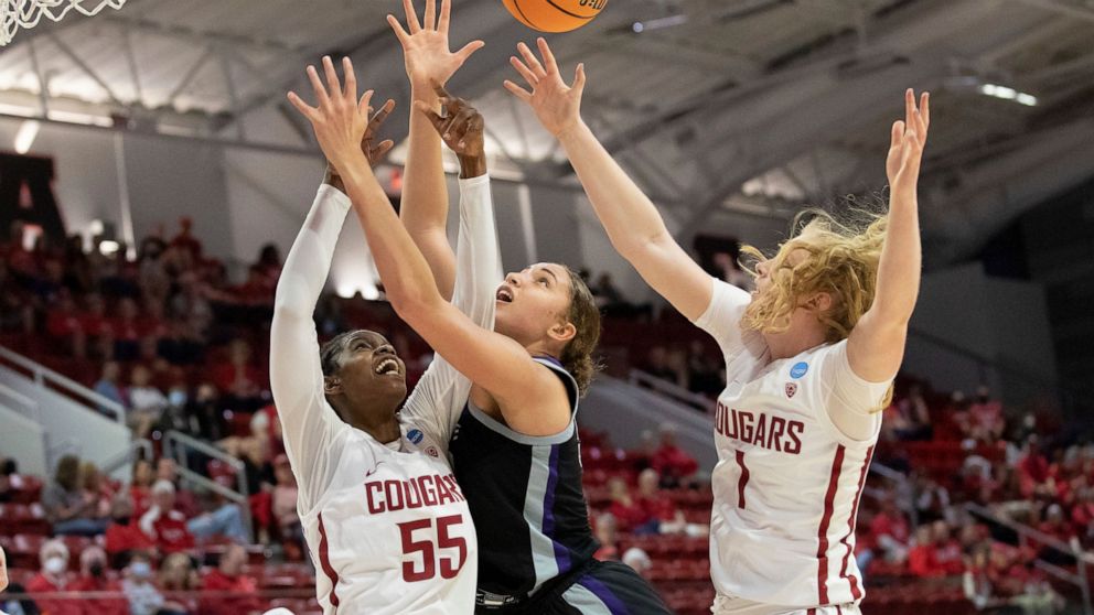 Washington State's Bella Murekatete (55) and Tara Wallack (1) battle for a rebound with Kansas State's Ayoka Lee, middle, during the first half of a college basketball game in the first round of the NCAA tournament in Raleigh, N.C., Saturday, March 1