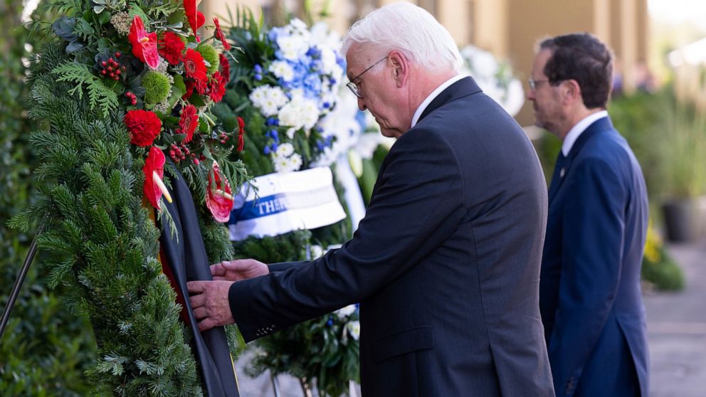 German President Frank-Walter Steinmeier, left, and Israeli President Isaac Herzog, right, attend a wreath laying ceremony to commemorate the victims of the attack by Palestinian militants on the 1972 Munich Olympics in Fuerstenfeldbruck near Munich,