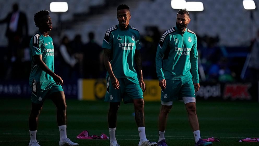 Real Madrid's Vinicius Junior, left, Real Madrid's Eder Militao, center, and Real Madrid's Karim Benzema gesture during a training session at the Stade de France in Saint Denis near Paris, Friday, May 27, 2022. Liverpool and Real Madrid are making th