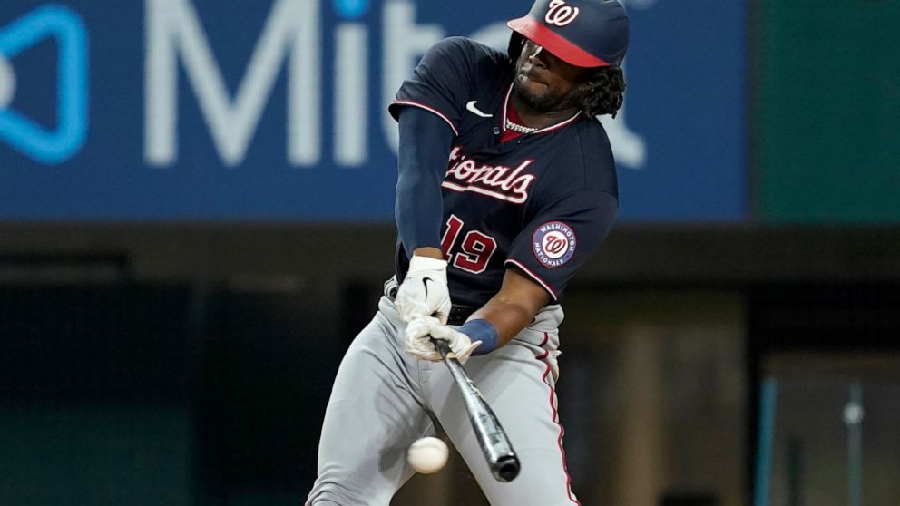 Washington Nationals' Josh Bell connects for a run-scoring single in the eighth inning of a baseball game against the Texas Rangers, Friday, June 24, 2022, in Arlington, Texas. Juan Soto scored on the hit. (AP Photo/Tony Gutierrez)