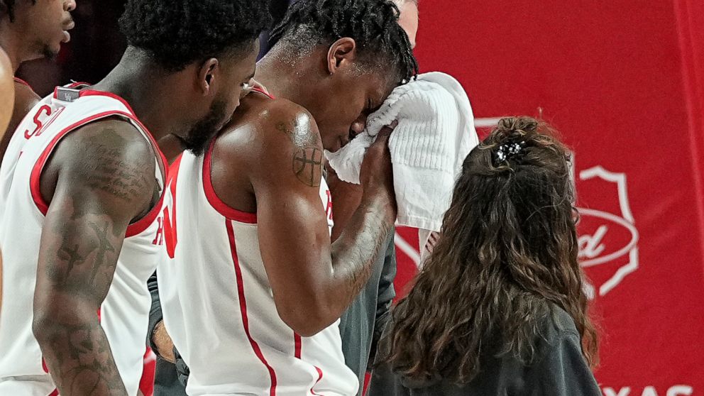 Houston guard Marcus Sasser exits the game after sustaining an injury to his face during the first half of an NCAA college basketball game against North Florida, Tuesday, Dec. 6, 2022, in Houston. (AP Photo/Kevin M. Cox)