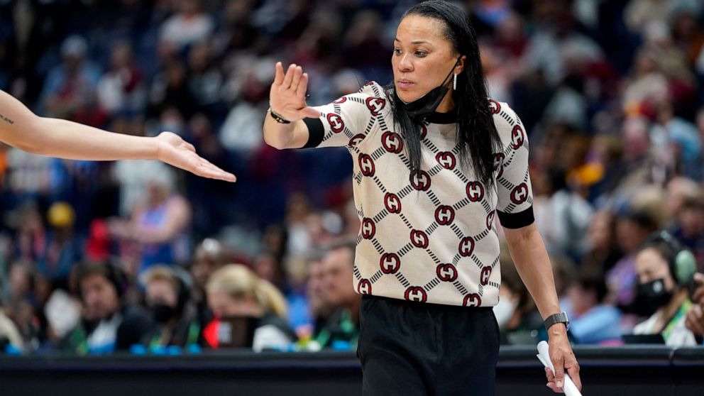 South Carolina head coach Dawn Staley congratulates a player during the second half of an NCAA college basketball semifinal round game against Mississippi at the women's Southeastern Conference tournament Saturday, March 5, 2022, in Nashville, Tenn. 