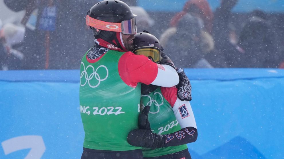 United States' Nick Baumgartner and United States' Lindsey Jacobellis celebrate after winning a gold medal in the mixed team snowboard cross finals at the 2022 Winter Olympics, Saturday, Feb. 12, 2022, in Zhangjiakou, China. (AP Photo/Lee Jin-man)