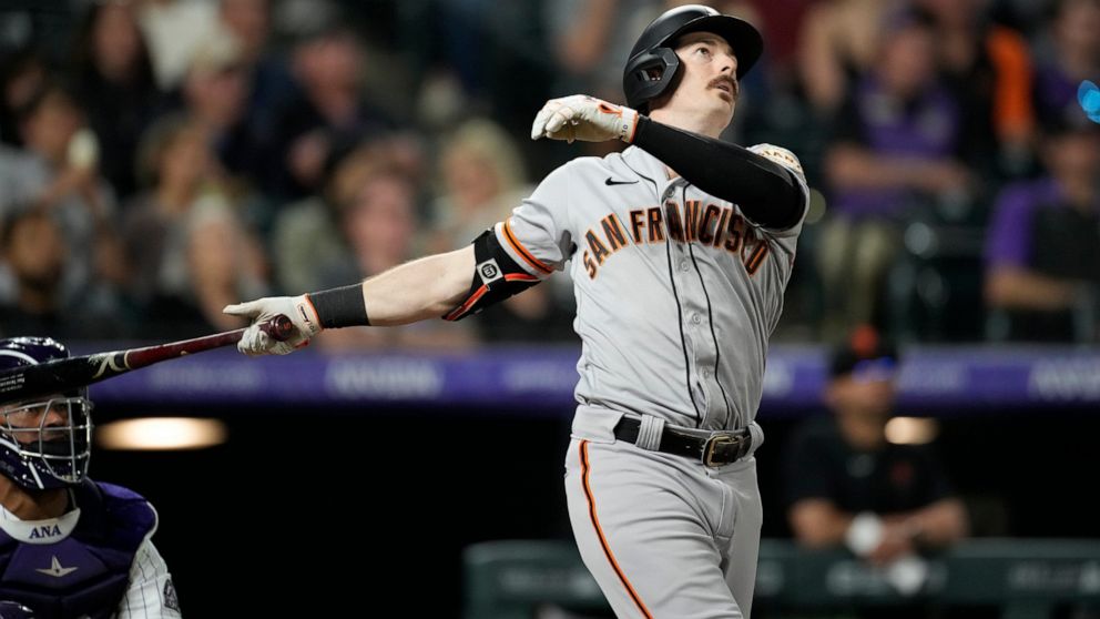 San Francisco Giants' Mike Yastrzemski follows the flight of his solo home run off Colorado Rockies relief pitcher Daniel Bard in the ninth inning of a baseball game Monday, May 16, 2022, in Denver. (AP Photo/David Zalubowski)